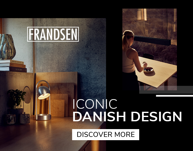 Frandsen Danish design lighting featuring a compact metallic table lamp on a wooden desk and a pendant lamp above a dining table with warm sunset lighting.