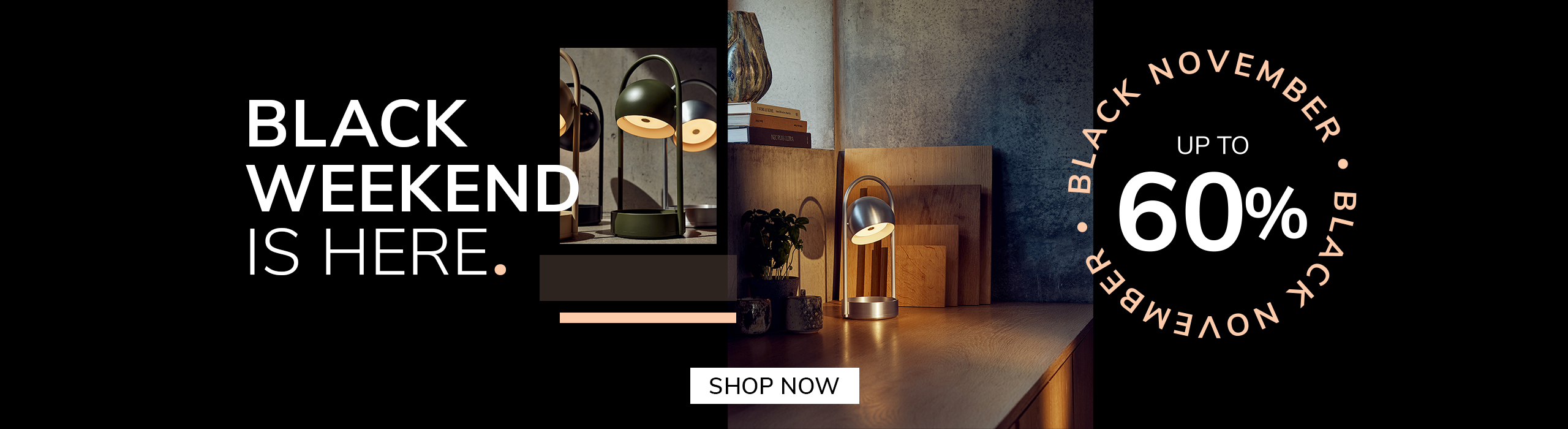 Modern silver table lamp glowing on a wooden desk with cutting boards and plants in the background. Promotional text reads: &lsquo;Black Weekend is here. Up to 60%. Black November.&rsquo; A button says &lsquo;Save Now.&rsquo;